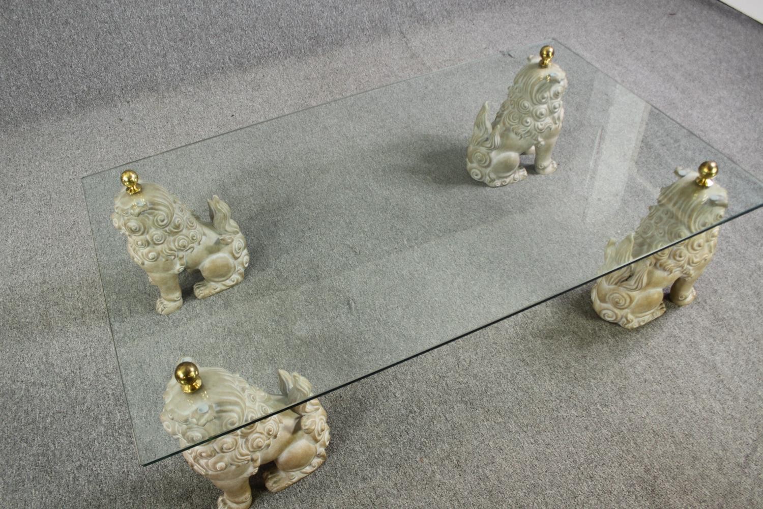 An unusual glass coffee table, with painted fu dog supports, 20th century. H.39 L.152 W.92cm. - Image 2 of 11