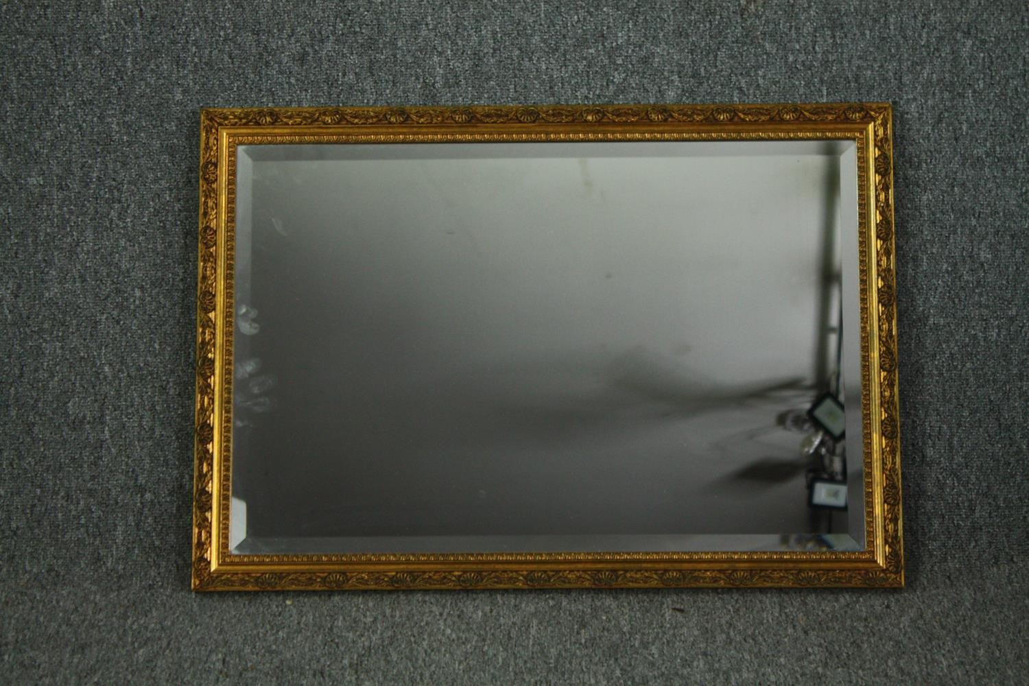 A contemporary gilt framed wall mirror. H.54 W.75cm.