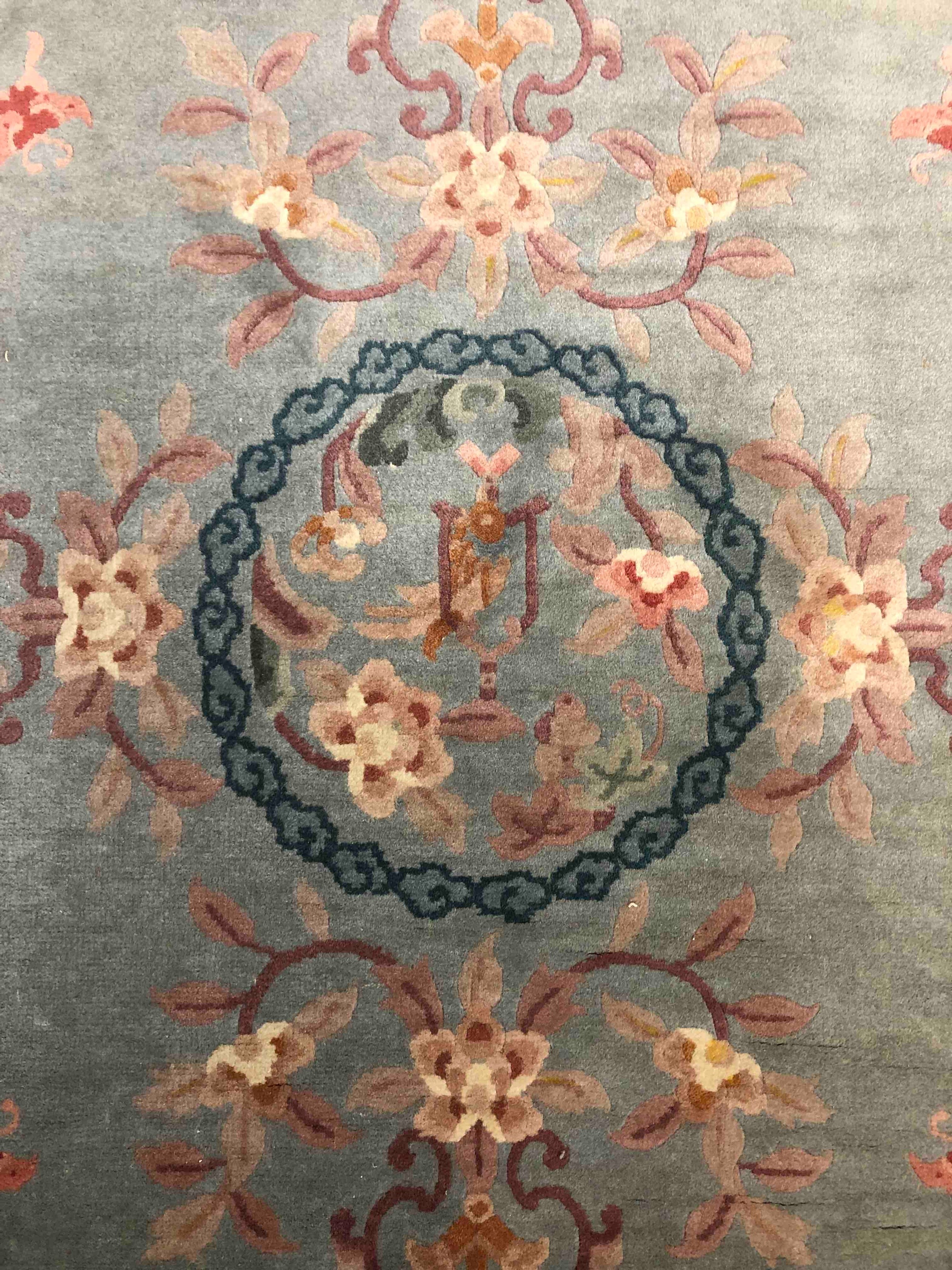 A Chinese woollen carpet with central flowerhead medallion within complementary burgundy borders. - Image 3 of 4