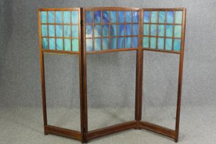 An oak and glass panelled Arts and Crafts folding room divider, early 20th century. H.141 W.160cm.