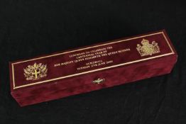 A boxed luncheon menu scroll to celebrate the centennial of The Queen Mother in 2000. H.39 W.29cm.