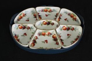 A set of Wedgwood Imperial porcelain serving dishes decorated with botanical fruits, within a fitted