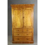 A Victorian satinwood linen press, fitted with slides above drawers on a plinth base. H.205 W.115