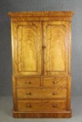 A Victorian satinwood linen press, fitted with slides above drawers on a plinth base. H.205 W.115