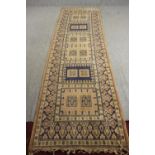 An Eastern runner with geometric design within multiple borders. L.330 W.92cm.