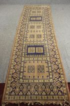 An Eastern runner with geometric design within multiple borders. L.330 W.92cm.