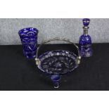 A collection of cobalt Bohemian glass, including a silvered blue decanter and shot glass with