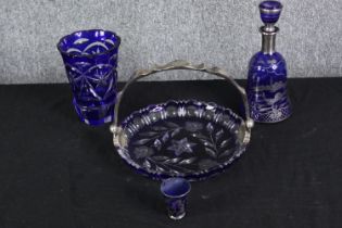 A collection of cobalt Bohemian glass, including a silvered blue decanter and shot glass with