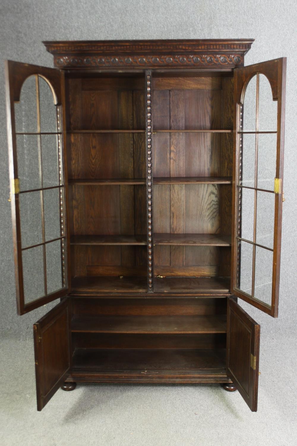An oak bookcase, mid 20th century, one glass pane is missing. H.209 W.115 D.36cm. - Image 4 of 8