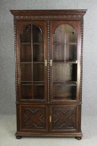 An oak bookcase, mid 20th century, one glass pane is missing. H.209 W.115 D.36cm.