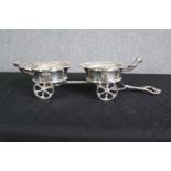 A silver plated decanter stand, in the form of a carriage, 19th century, in the rococo taste. H.14