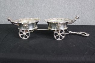 A silver plated decanter stand, in the form of a carriage, 19th century, in the rococo taste. H.14