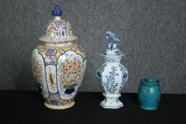 A collection of ceramics, including two early 19th century Delft lidded urns, one (De Porceleyne