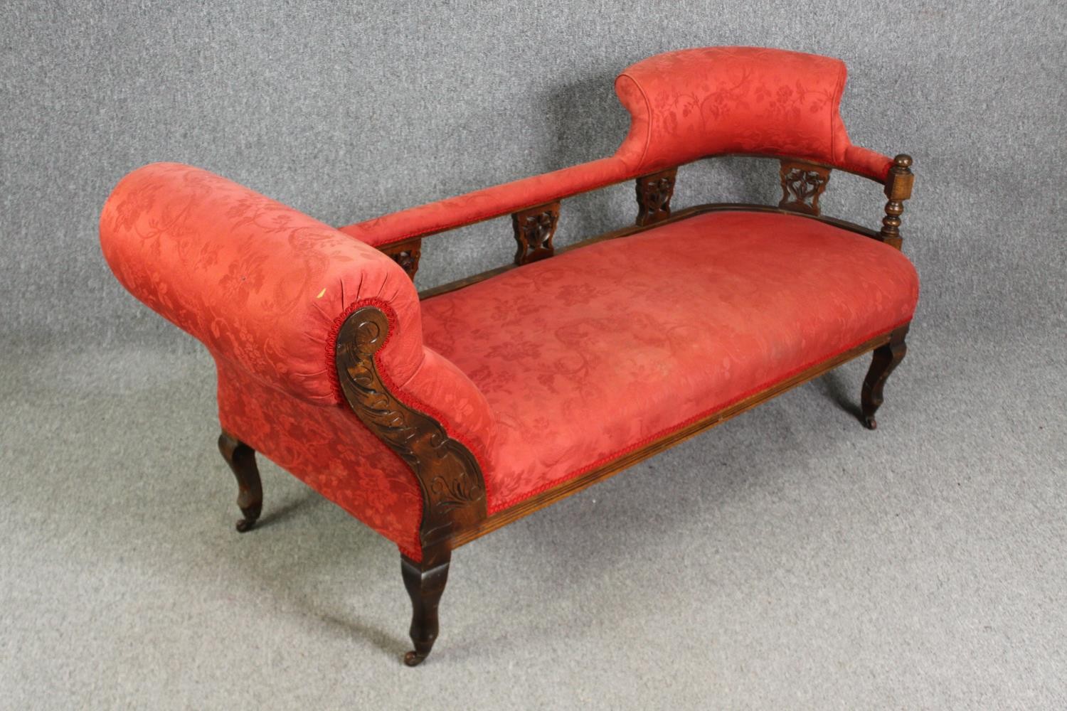 A late Victorian carved walnut chaise longue, with red damask upholstery, H.78 W.180 D.53cm. - Image 4 of 7