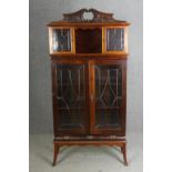 An Edwardian mahogany carved and glazed display cabinet, H.190 W.94 D.40cm.