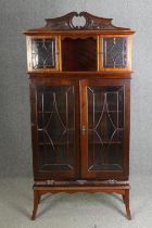An Edwardian mahogany carved and glazed display cabinet, H.190 W.94 D.40cm.