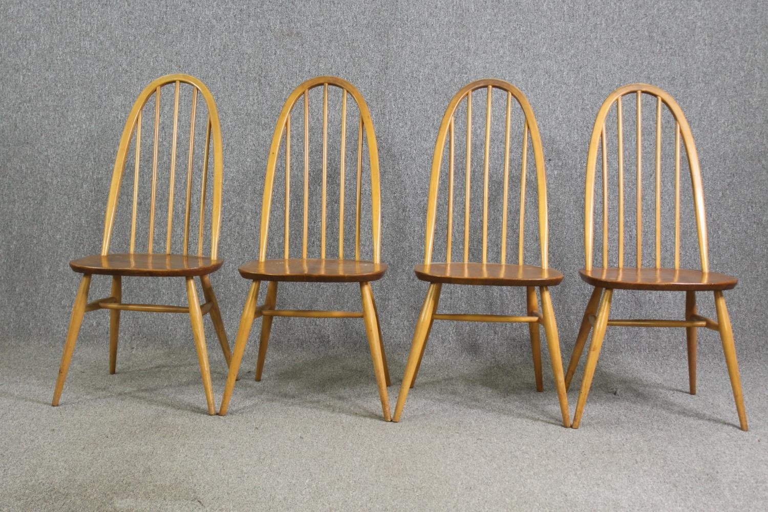 A set of four Ercol beech and light elm dining chairs.