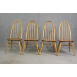 A set of four Ercol beech and light elm dining chairs.
