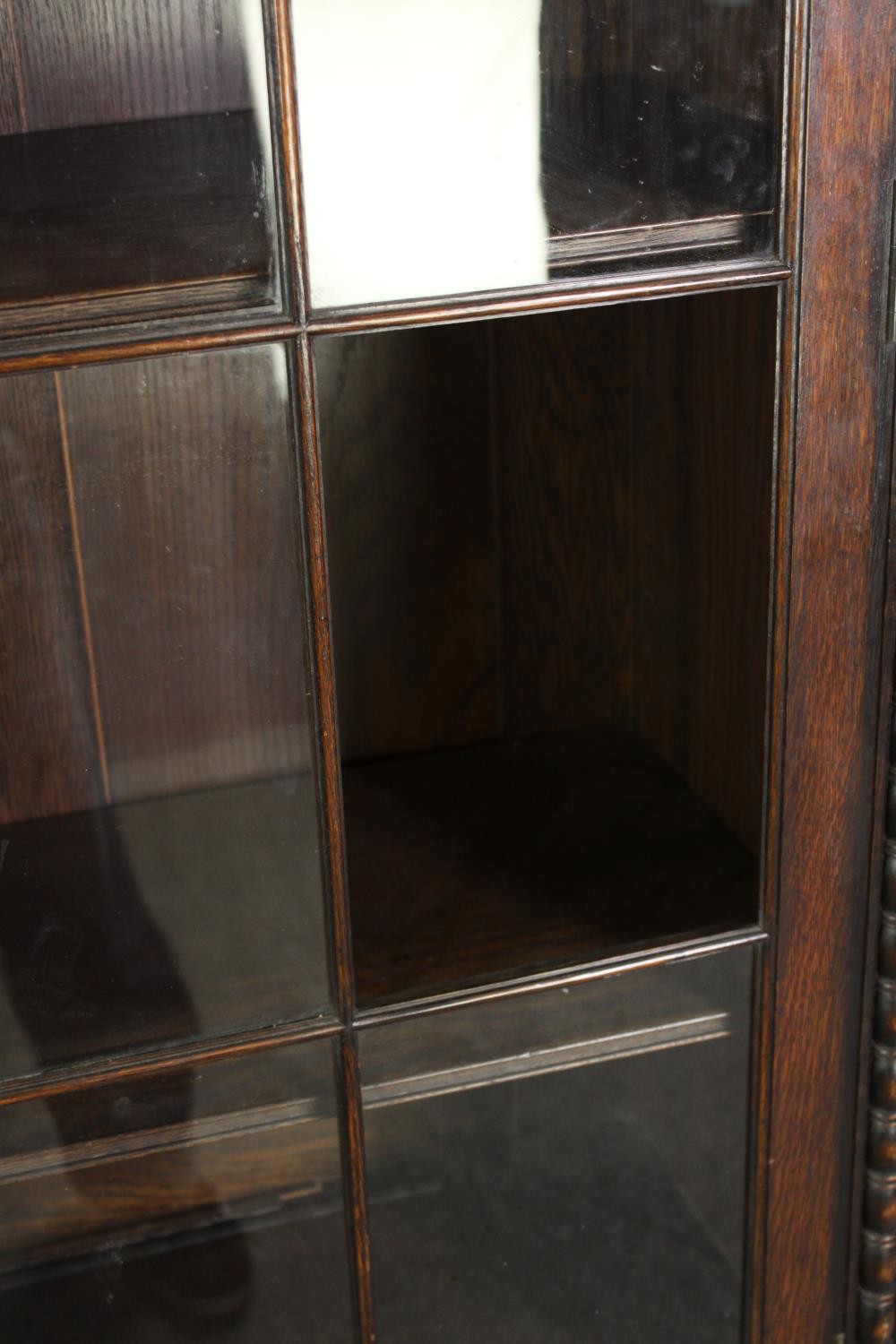 An oak bookcase, mid 20th century, one glass pane is missing. H.209 W.115 D.36cm. - Image 8 of 8