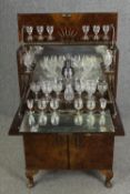 An Art Deco burr walnut cocktail cabinet, circa 1930, enclosing various cut drinking glasses and a