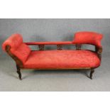 A late Victorian carved walnut chaise longue, with red damask upholstery, H.78 W.180 D.53cm.