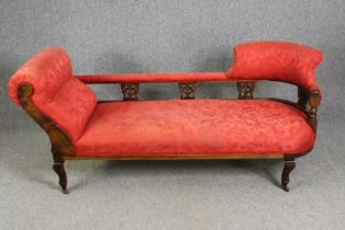 A late Victorian carved walnut chaise longue, with red damask upholstery, H.78 W.180 D.53cm.