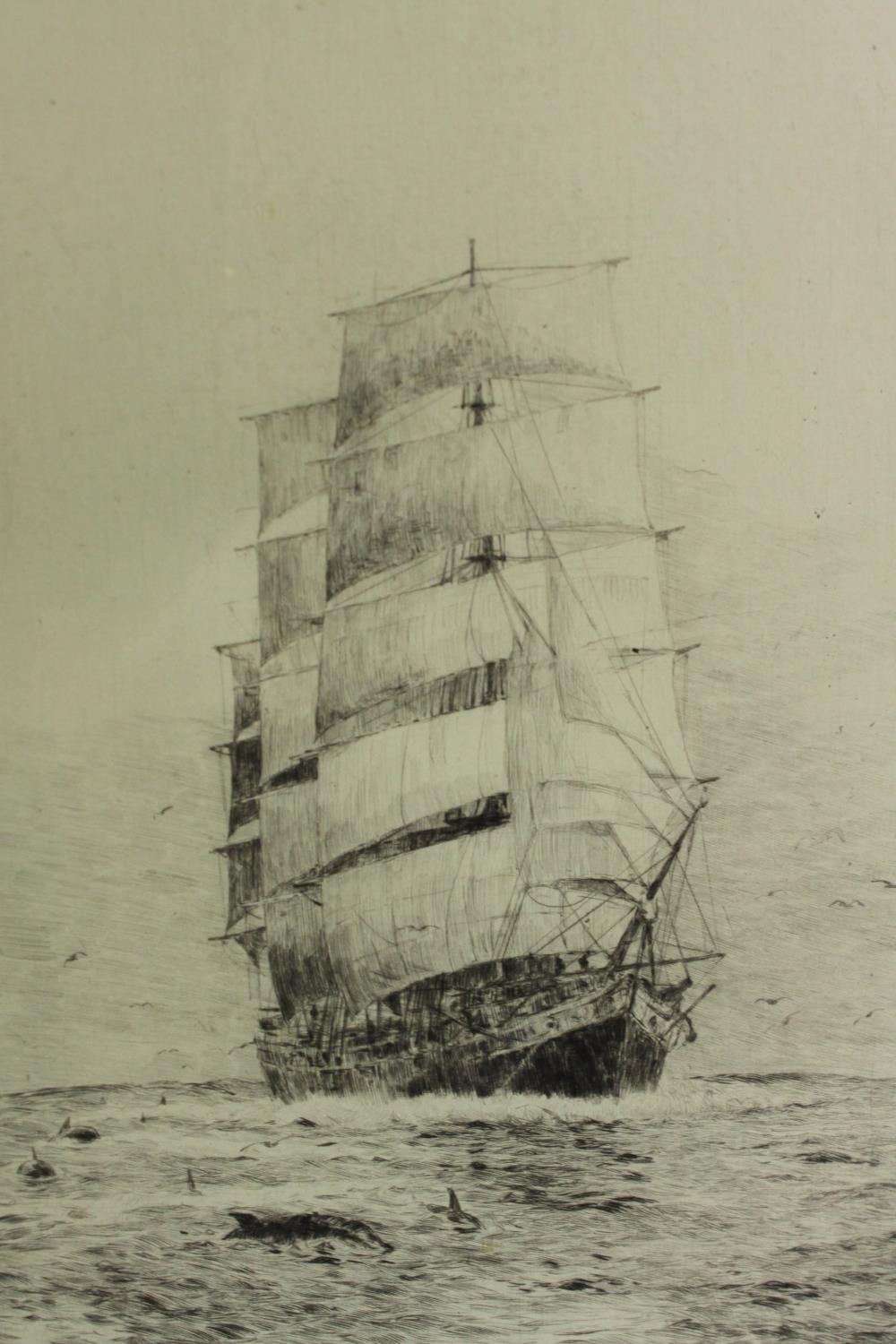 A signed framed and glazed etching of a clipper in full sail, by Rowland Langmaid. H.53 W.38cm.