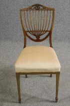 An Edwardian rosewood and inlaid side chair in the Sheraton style.