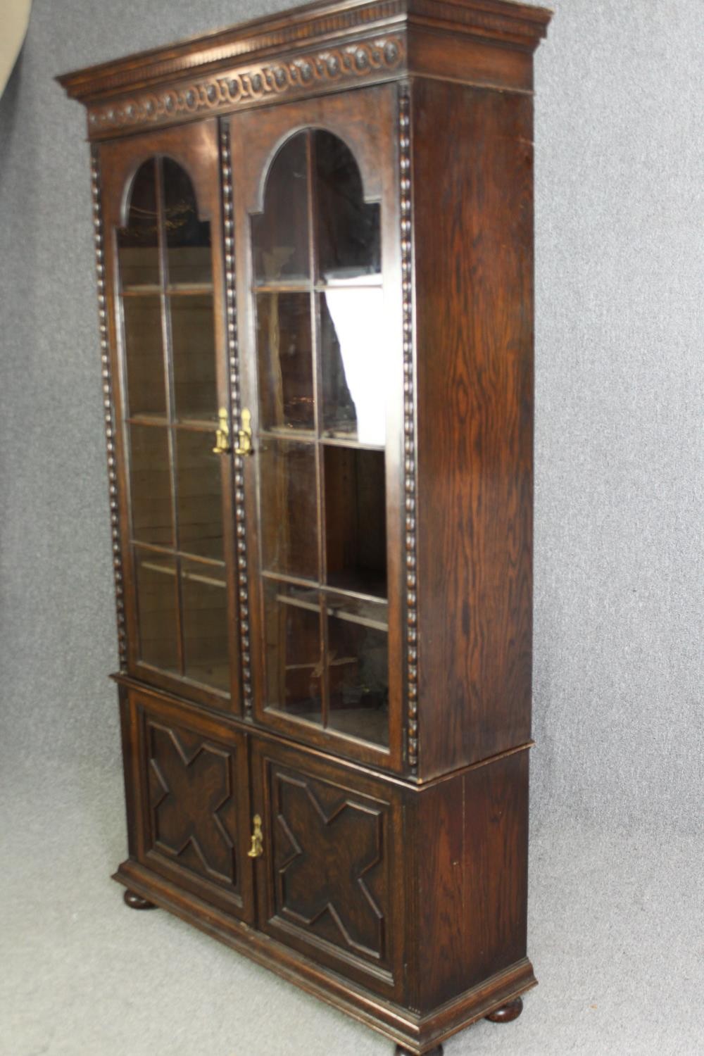 An oak bookcase, mid 20th century, one glass pane is missing. H.209 W.115 D.36cm. - Image 3 of 8