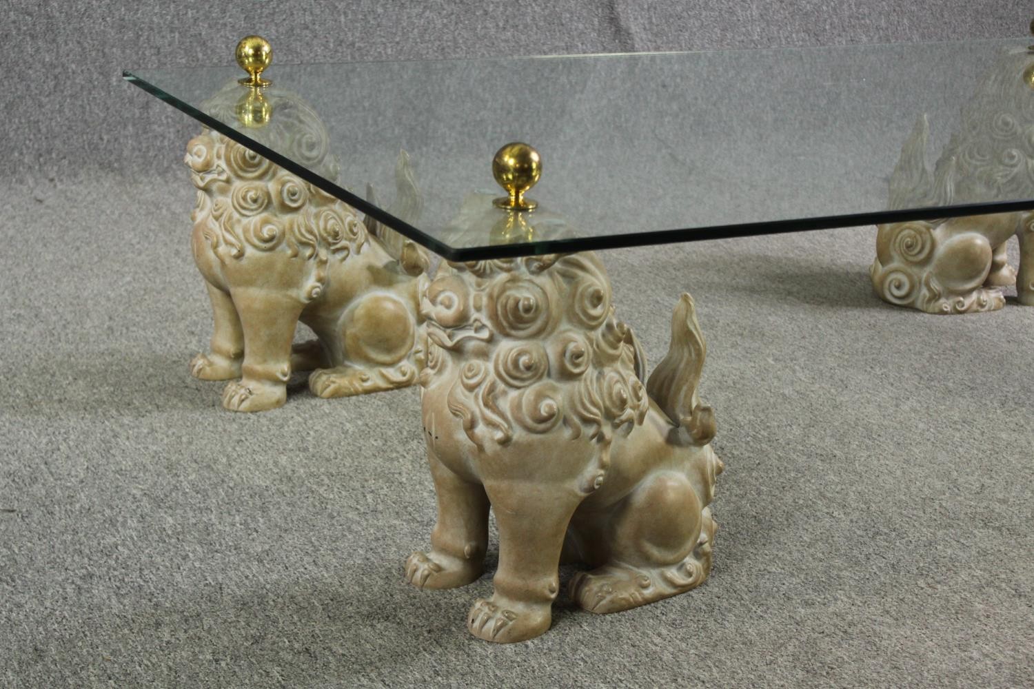 An unusual glass coffee table, with painted fu dog supports, 20th century. H.39 L.152 W.92cm. - Image 10 of 11