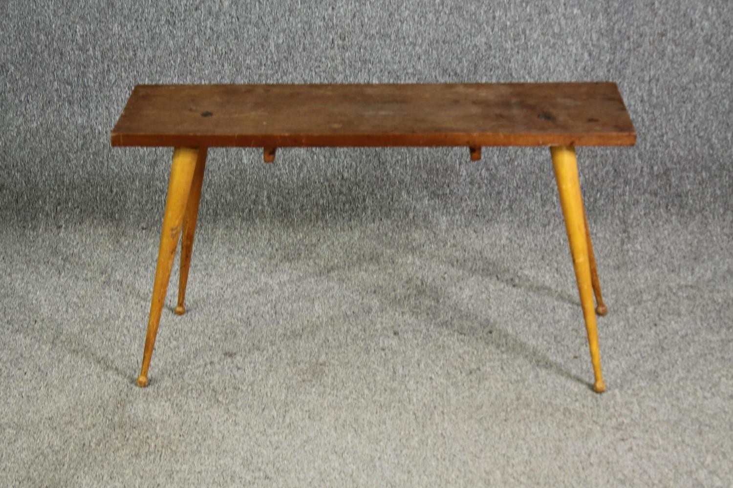 An Ercol style beech side table, with associated top and base. H.49 W.90 D.29.5cm.