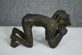 A bronze figure of a crouching man, possibly African. H.10cm.
