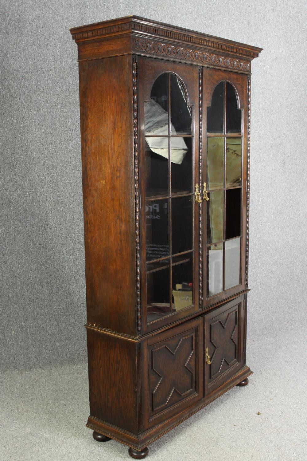 An oak bookcase, mid 20th century, one glass pane is missing. H.209 W.115 D.36cm. - Image 2 of 8