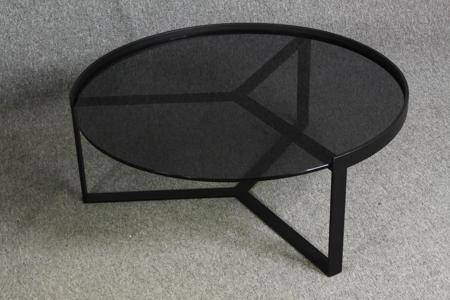 Two contemporary coffee tables with tinted glass tops and black metal supports. H.35 Dia.89cm. ( - Image 2 of 10