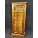 A walnut and glazed display cabinet, 20th century. H. 154 W.66 D.36cm.