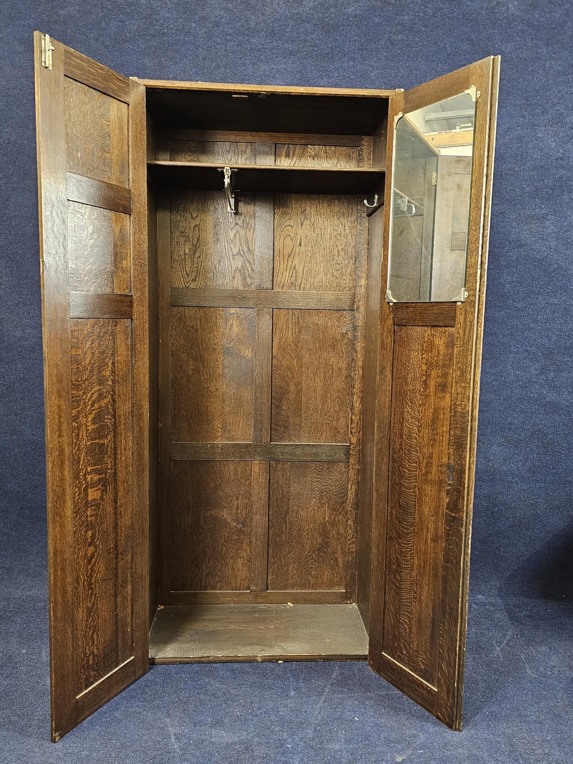 A narrow oak wardrobe, first half 20th century with maker's label. H.73 W.76 D.40cm. - Image 5 of 7