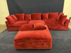 A large modern sofa in red upholstery, with a matching stool. H.60 W.330 in three parts D.120.cm