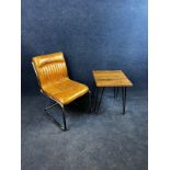 A modern leather and chrome cantilevered chair, and a side table on hairpin supports. Table H.56 W.