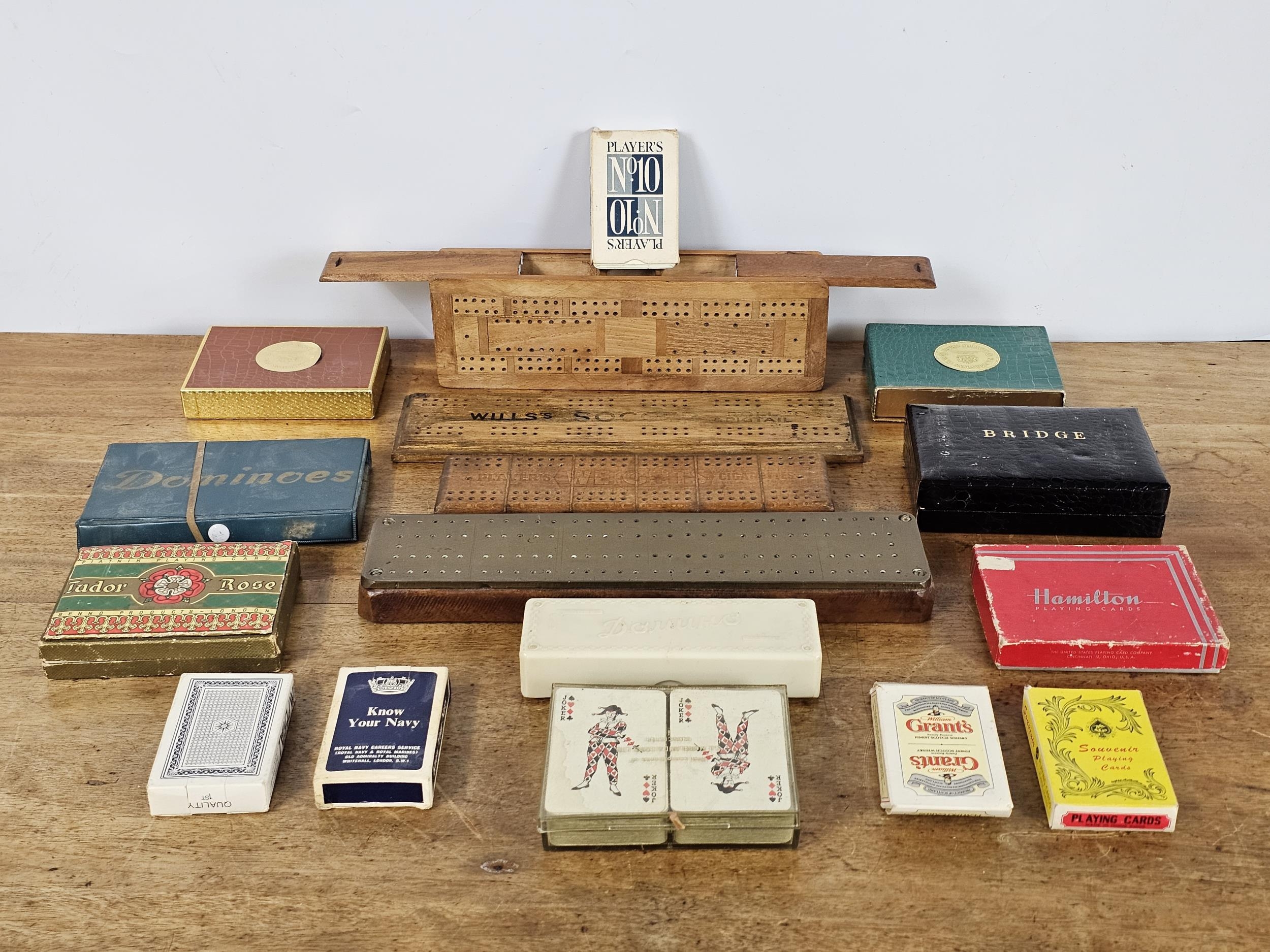 A group of vintage games, including cribbage boards, cards & dominoes