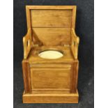 An elm campaign style commode chair with hinged lid. H.84 W.51 D.45cm.