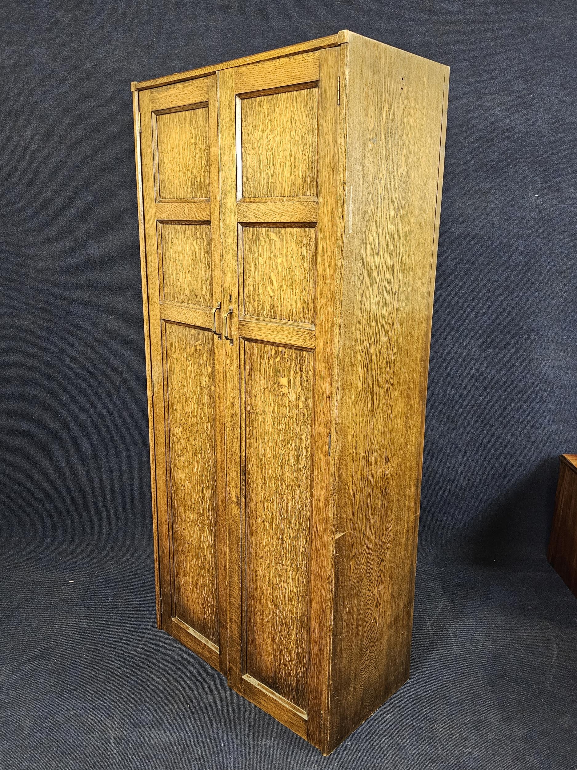 A narrow oak wardrobe, first half 20th century with maker's label. H.73 W.76 D.40cm. - Image 2 of 7