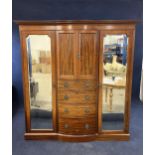 A mahogany and mirrored, break bow front wardrobe, 20th century. H.210 W.186 D.60.cm