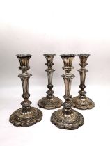 Two pairs of 19th century Sheffield silver plate repousse weighted candlesticks with floral