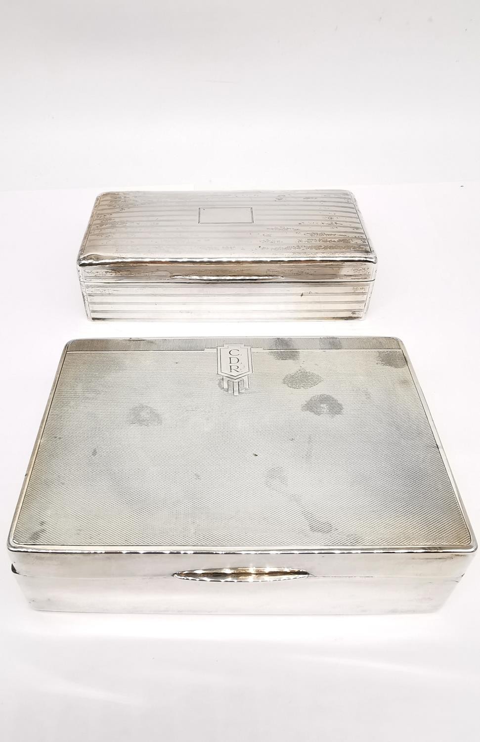 Two silver cedar lined cigarette boxes, one by William Neale with engraved monogram and geometric