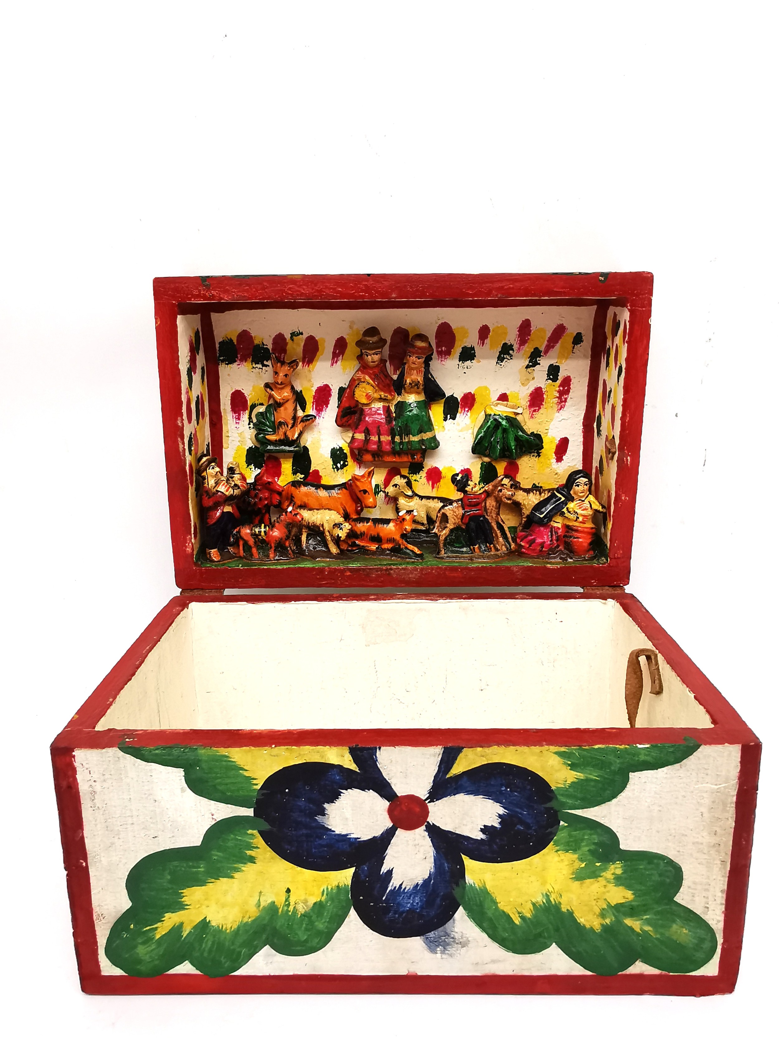 A Mexican folk art painted wooden casket with a carved frieze to the inside of lid depicting