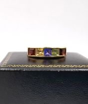 A 14 carat yellow gold multi gem-set band. Set with peridot, garnet, Citrine and amethyst. Stamped