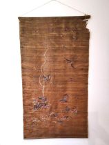 A Chinese 19th Chinese silk embroidered wall hanging decorated with a tree with birds and