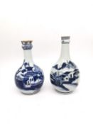 Two 18th century Chinese blue and white bottle vases with pagoda and mountain landscape design. H.