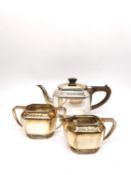 An Art Deco three piece silver tea set by Roberts & Belk, consisting of a teapot, twin handled sugar