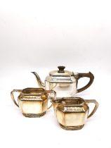 An Art Deco three piece silver tea set by Roberts & Belk, consisting of a teapot, twin handled sugar